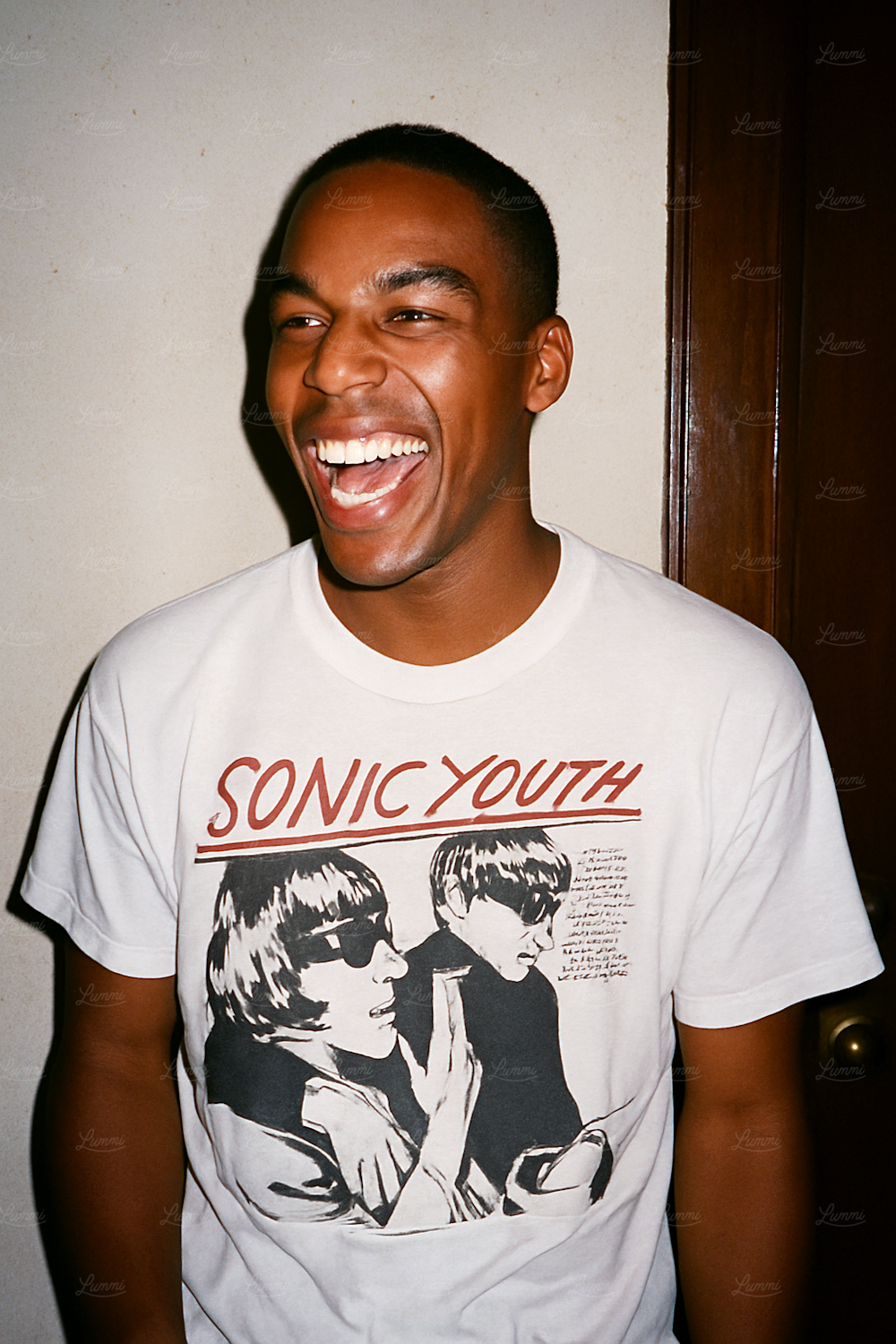 A person genuinely laughing while engaging with content on a screen, reflecting the article's call for humor that surprises and connects.