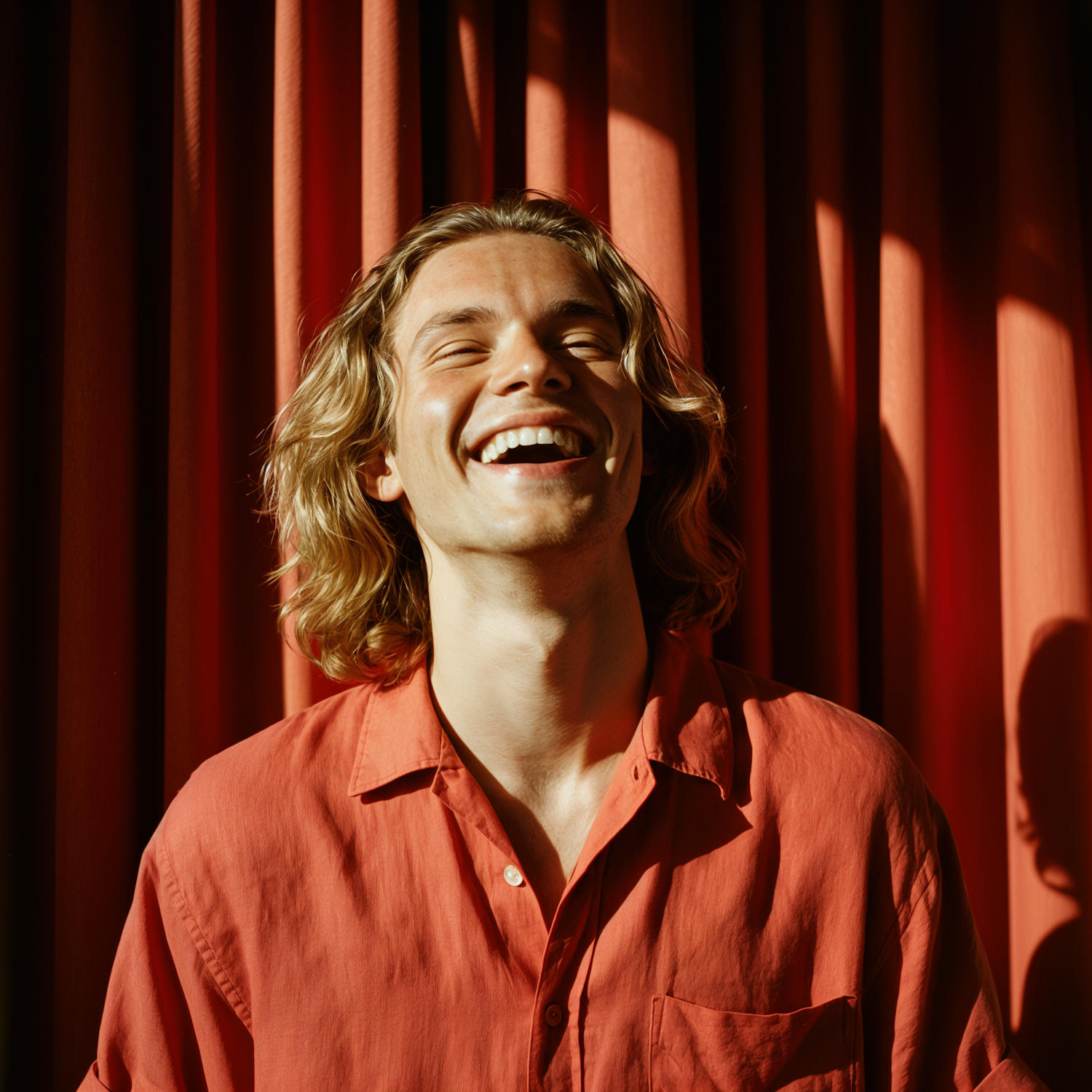 A person bursts into laughter, experiencing relief after a moment of tension or surprise.