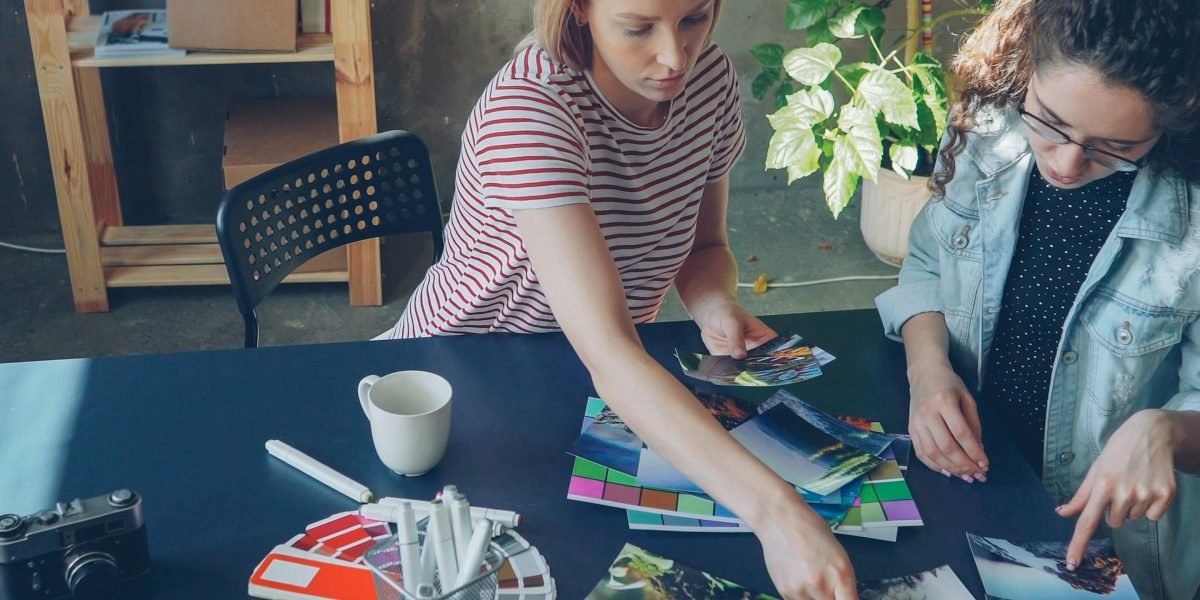A creative professional collaborating with a team to brainstorm fresh ideas, symbolizing the pursuit of original and engaging content.
