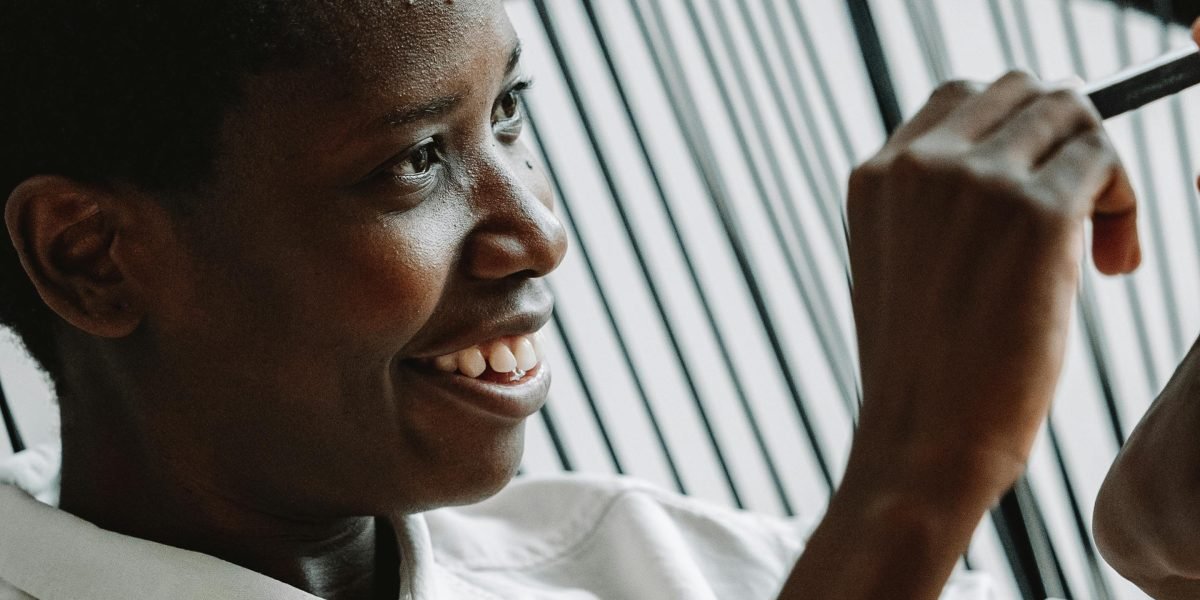 A person confidently laughing at themselves, symbolizing the power and refreshing nature of self-awareness in navigating public perception.