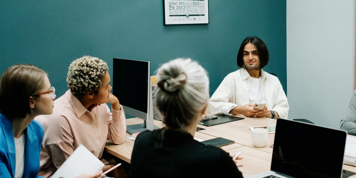 A marketing team reviews performance data, strategizing how to implement new content approaches for better engagement.
