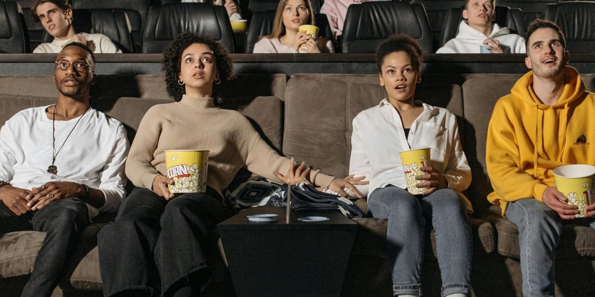 Friends share a laugh while watching a classic comedy, highlighting timeless humor.