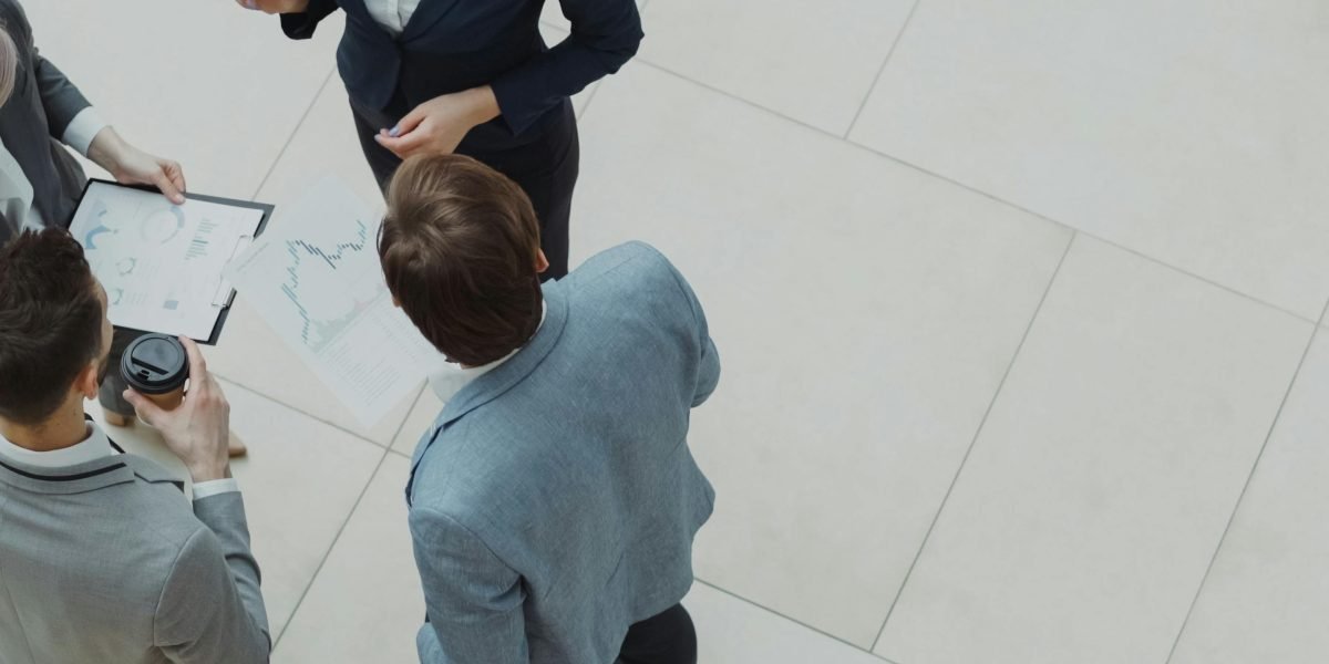 A professional leading a discussion or presentation, reflecting themes of ambition and high-stakes work environments.