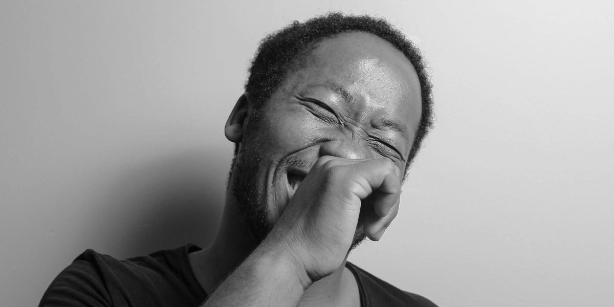 A person laughing genuinely, reflecting the impact of good comedic content.
