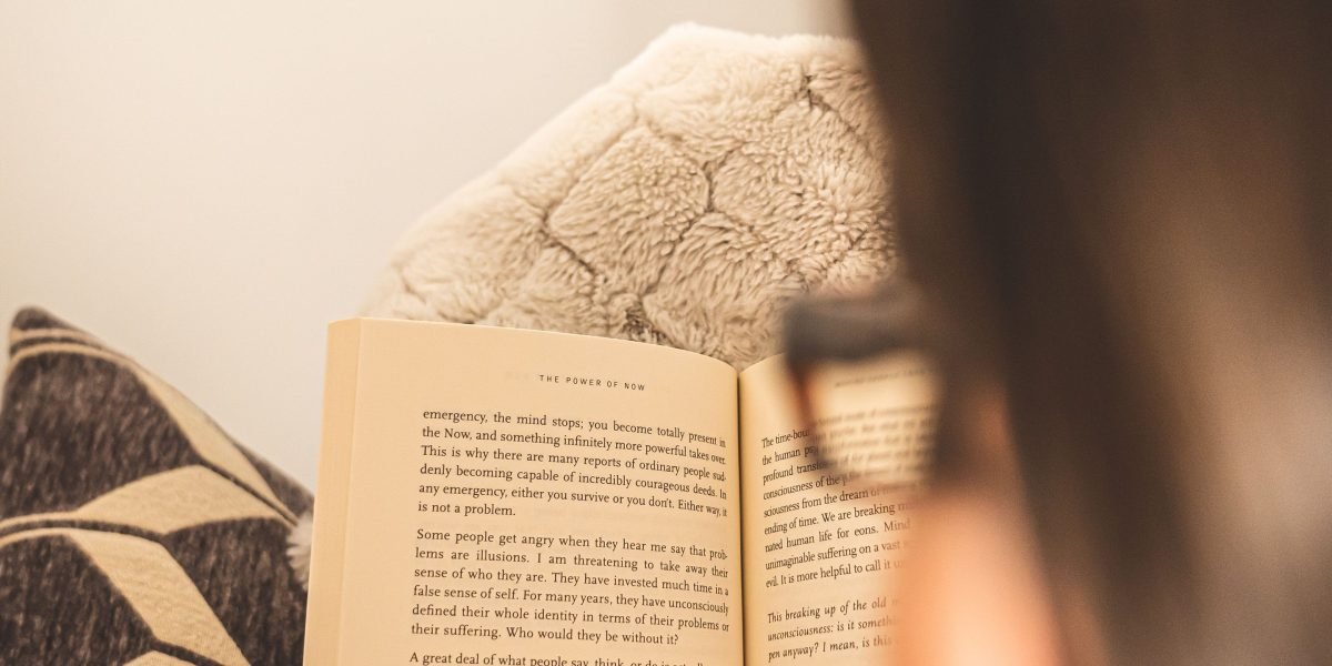 A person reading, engrossed in compelling, thought-provoking content.